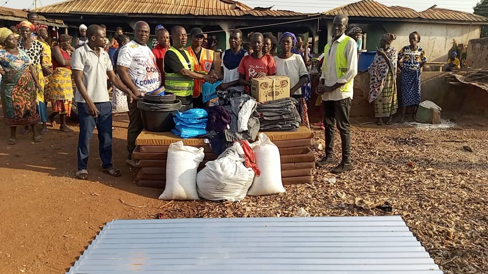 Geoffrey Kini donates relief items to support disabled fire victim